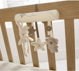 a crib with toys from it with text: 'X'